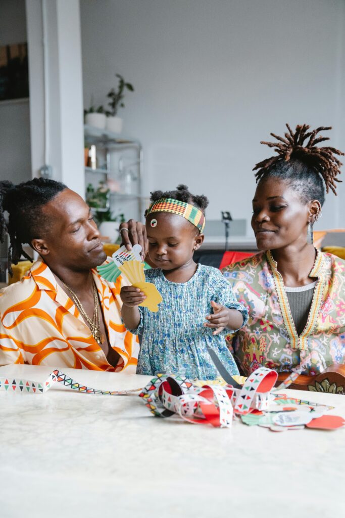 African American family enjoying quality time crafting together indoors.